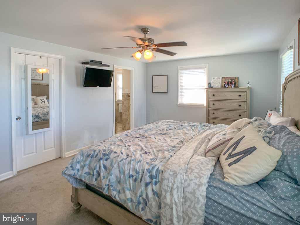 1148 Morefield Road Philadelphia, PA 19115 - Photo 16 of 35 a bedroom with a bed and a flat screen tv