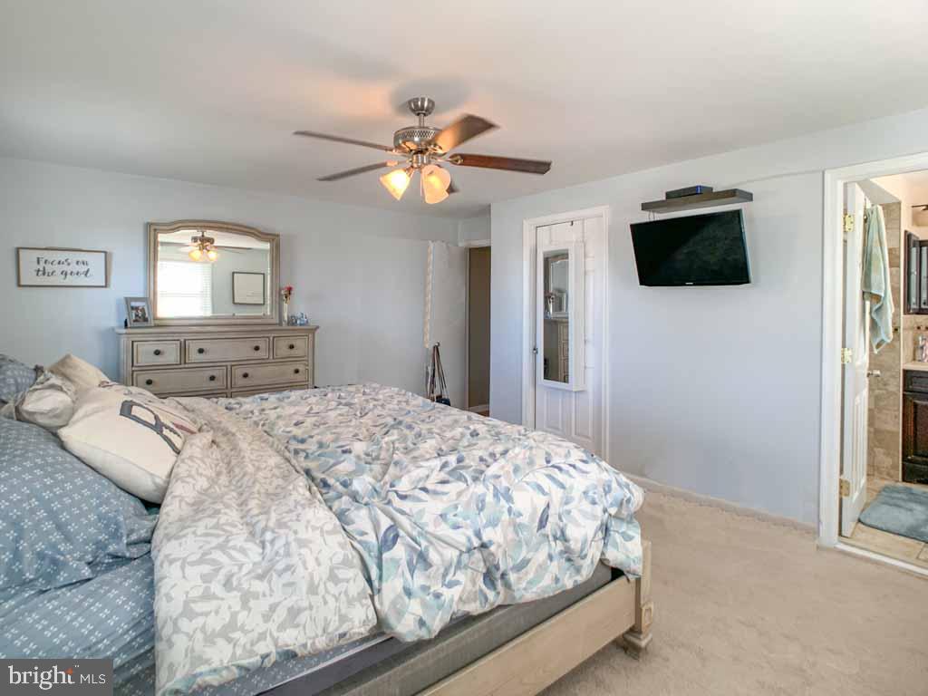 1148 Morefield Road Philadelphia, PA 19115 - Photo 17 of 35 a bedroom with a bed and a flat screen tv