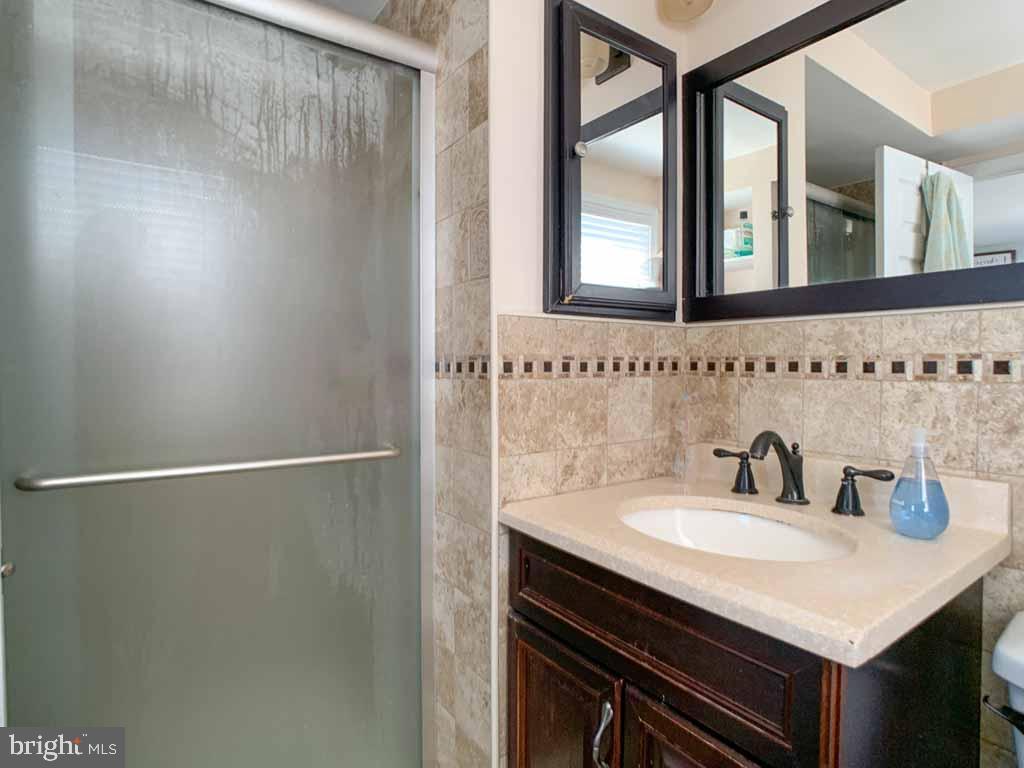1148 Morefield Road Philadelphia, PA 19115 - Photo 19 of 35 a bathroom with a sink and a mirror