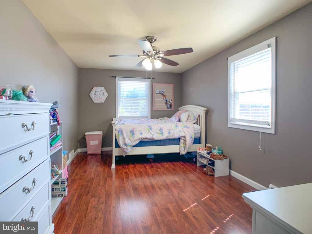 1148 Morefield Road Philadelphia, PA 19115 - Photo 20 of 35 a bedroom with a bed and a chandelier
