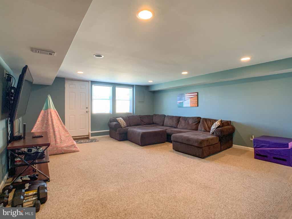 1148 Morefield Road Philadelphia, PA 19115 - Photo 25 of 35 a living room with furniture a window and a flat screen tv