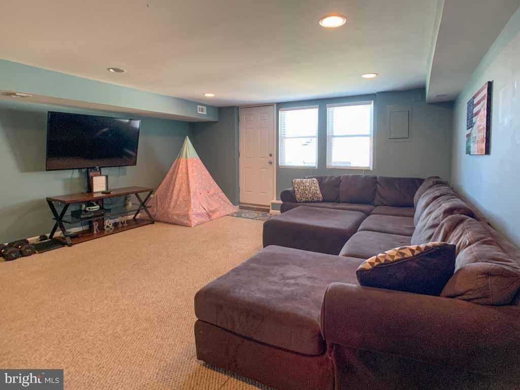 1148 Morefield Road Philadelphia, PA 19115 - Photo 26 of 35 a living room with furniture and a flat screen tv