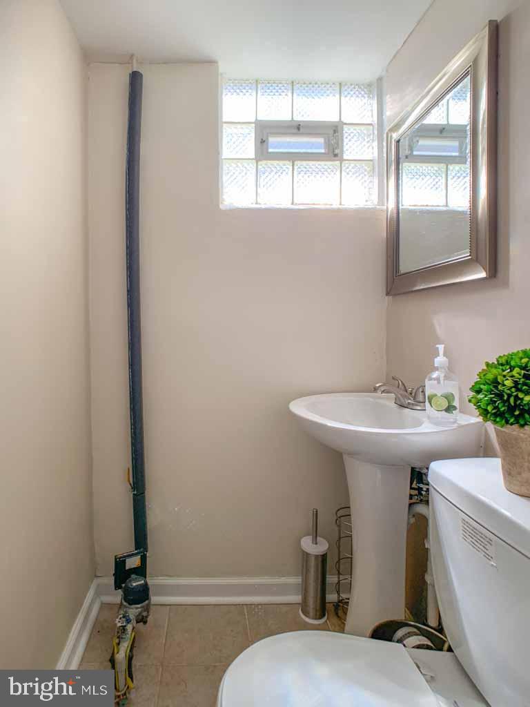 1148 Morefield Road Philadelphia, PA 19115 - Photo 29 of 35 a bathroom with a sink a toilet and mirror