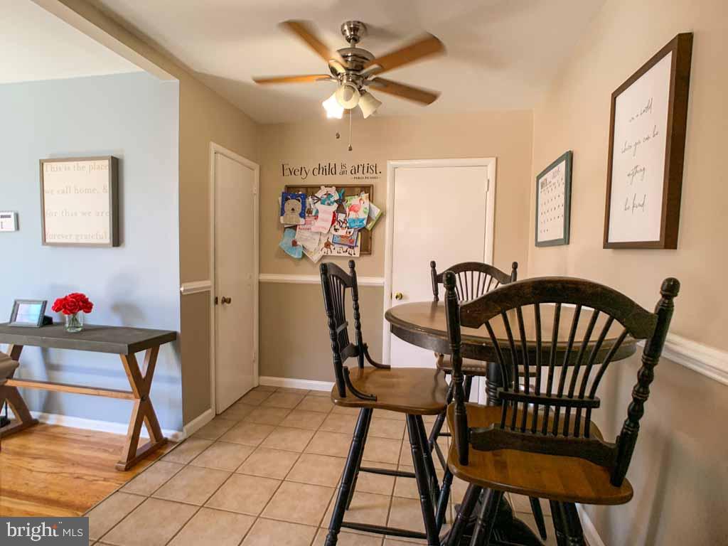 1148 Morefield Road Philadelphia, PA 19115 - Photo 10 of 35 a view of a dining room with furniture and a chandelier fan