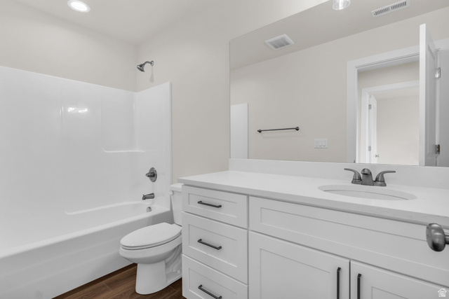 576 7th Avenue Midvale, UT 84047 - Photo 18 of 32 Full bathroom with bathing tub / shower combination, vanity, and dark wood finished floors