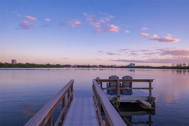 a view of a hallway with wooden floor and entryway