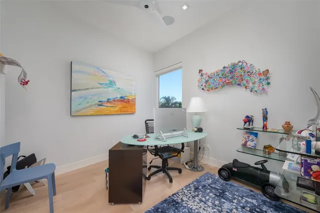 front view of a house with a yard and palm trees