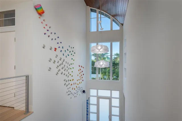 a view of a patio with table and chairs in front of it