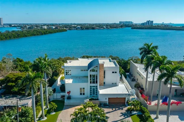 a view of a swimming pool with a patio and a yard