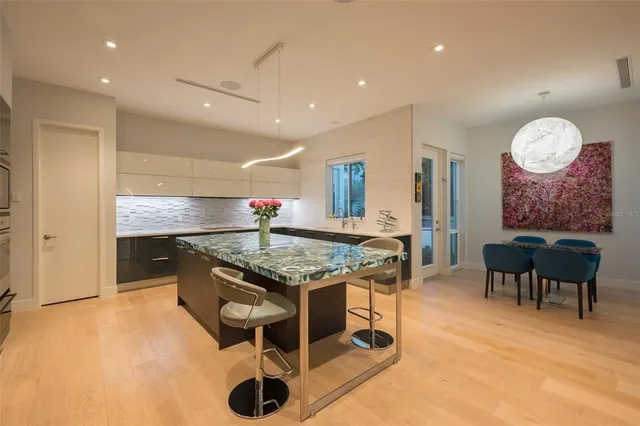 a kitchen with stainless steel appliances kitchen island granite countertop a sink and cabinets