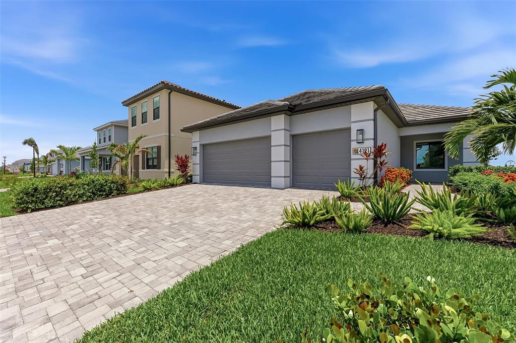 4191 Pegasus Way Naples, FL 34120 - Photo 2 of 48 a front view of a house with a garden