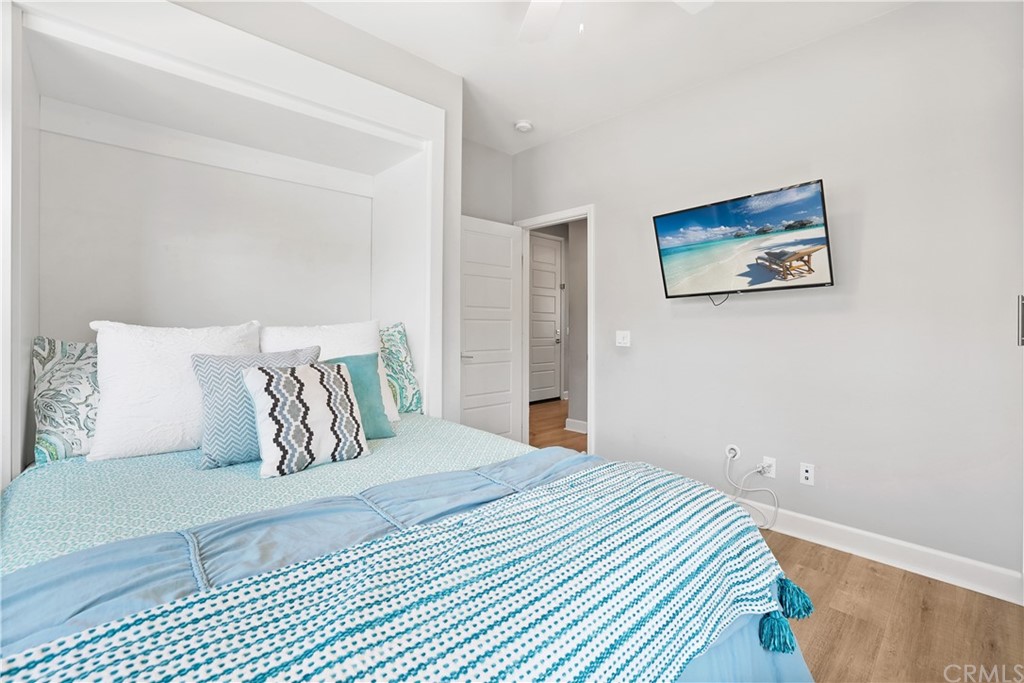 26 Lilac Lake Forest, CA 92630 - Photo 19 of 52 a bedroom with a large bed and a lamp on dresser