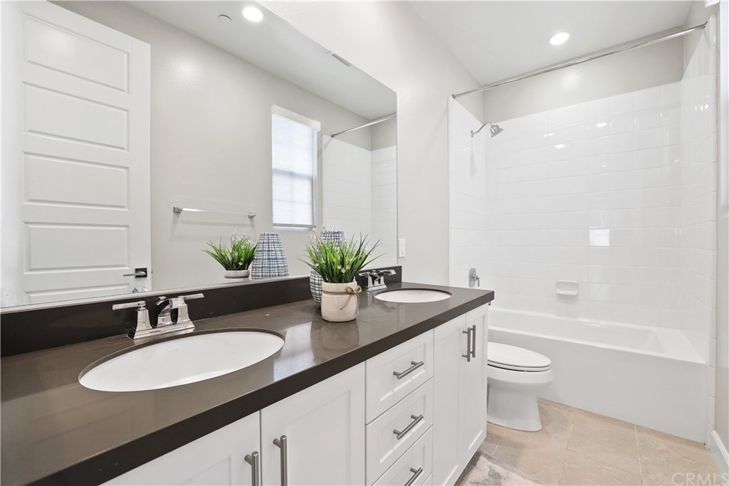 26 Lilac Lake Forest, CA 92630 - Photo 30 of 52 a bathroom with a granite countertop sink and a mirror