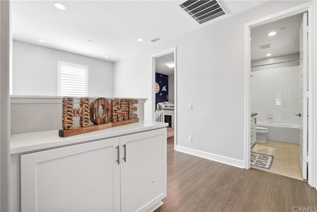 26 Lilac Lake Forest, CA 92630 - Photo 33 of 52 a view of kitchen with cabinets and wooden floor