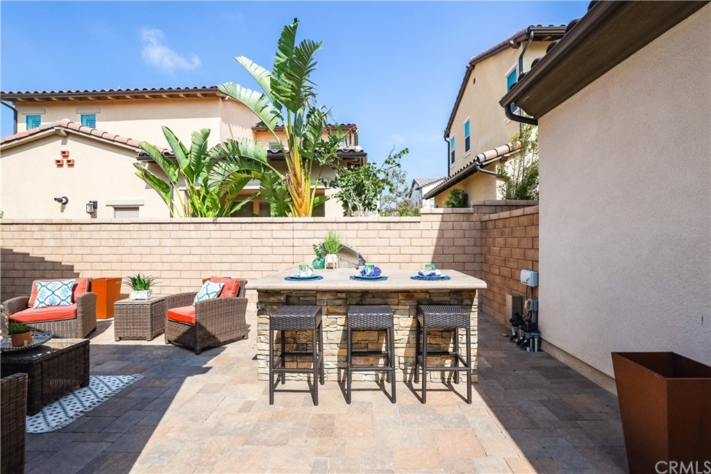 26 Lilac Lake Forest, CA 92630 - Photo 38 of 52 a roof deck with table and chairs a barbeque with potted plants