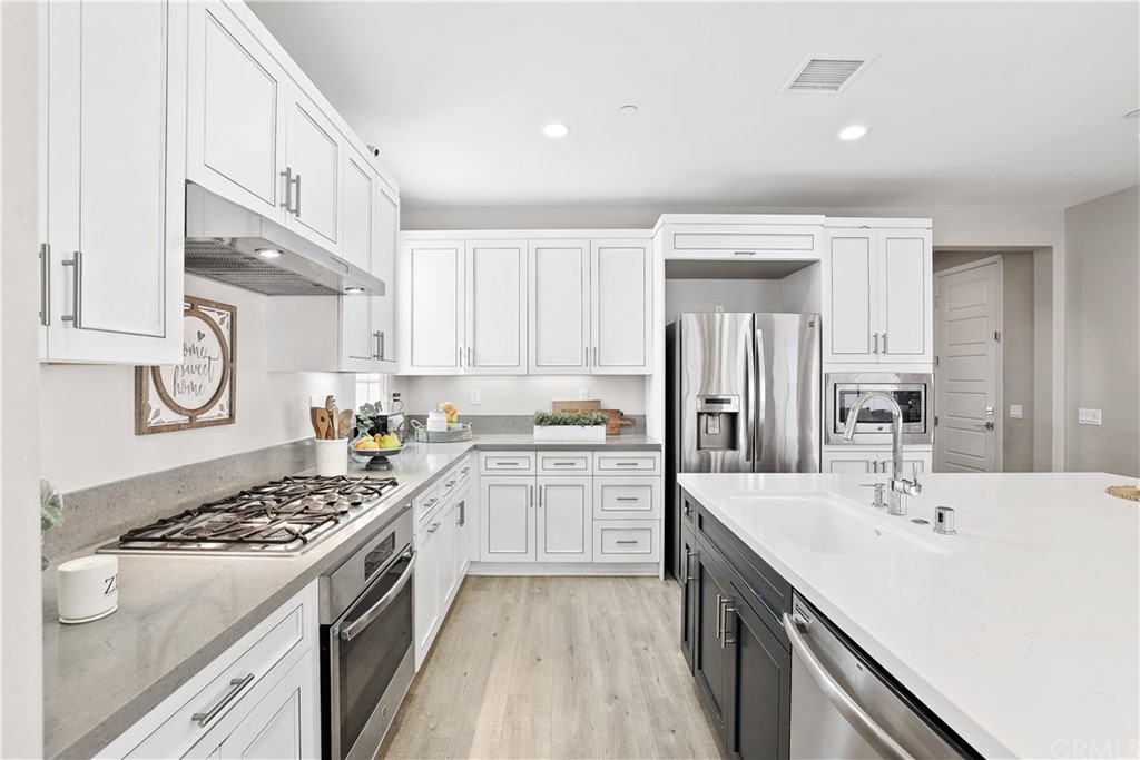 26 Lilac Lake Forest, CA 92630 - Photo 6 of 52 a kitchen with a sink stove and cabinets