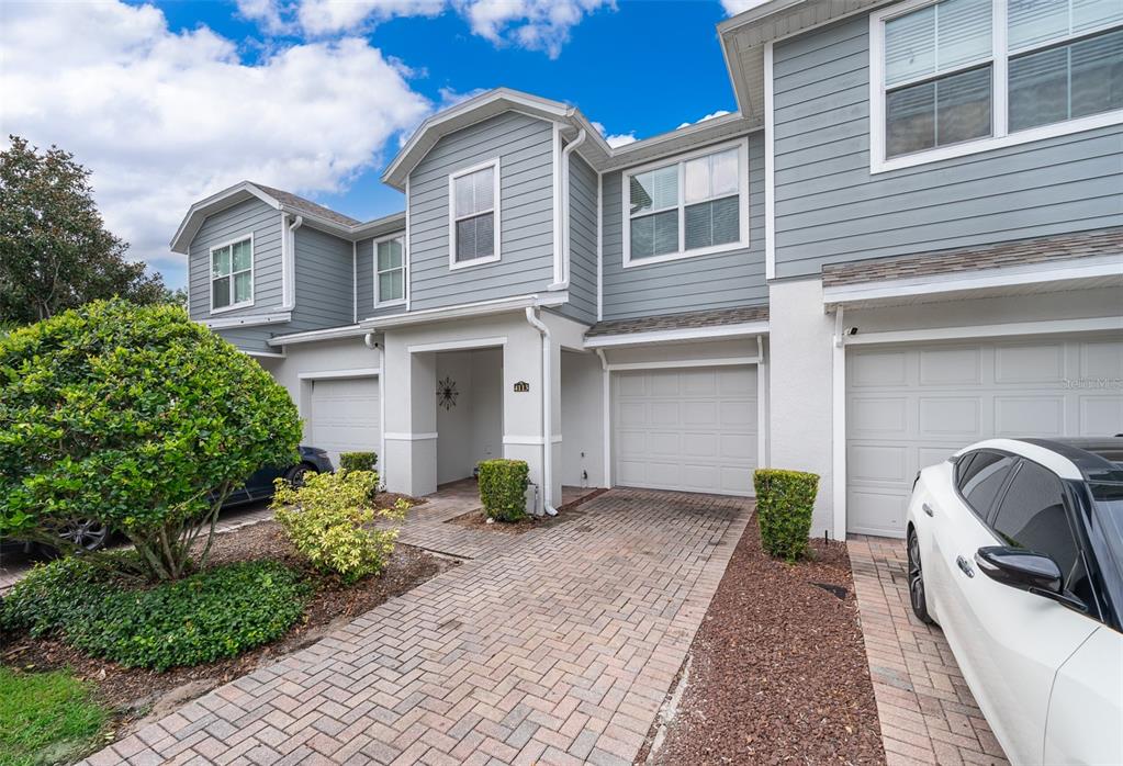 4113 Hedge Maple Place Winter Springs, FL 32708 - Photo 1 of 31 a front view of a house with garden