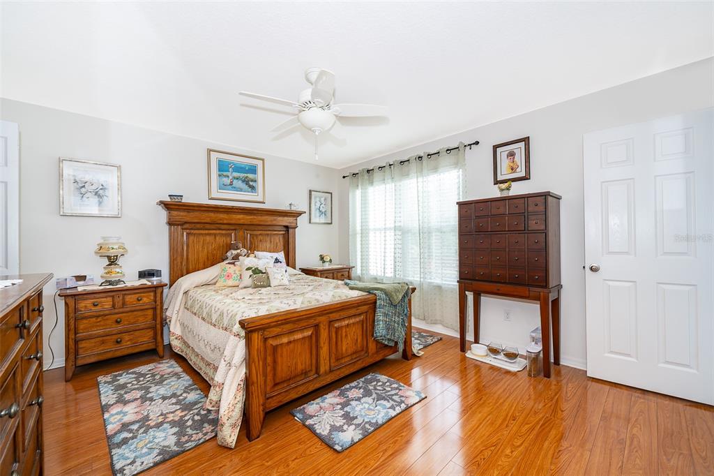 4113 Hedge Maple Place Winter Springs, FL 32708 - Photo 17 of 31 a bedroom with a bed and wooden floor
