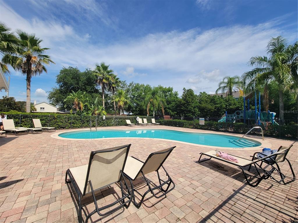 4113 Hedge Maple Place Winter Springs, FL 32708 - Photo 21 of 31 a view of swimming pool that has lawn chairs with plants and trees