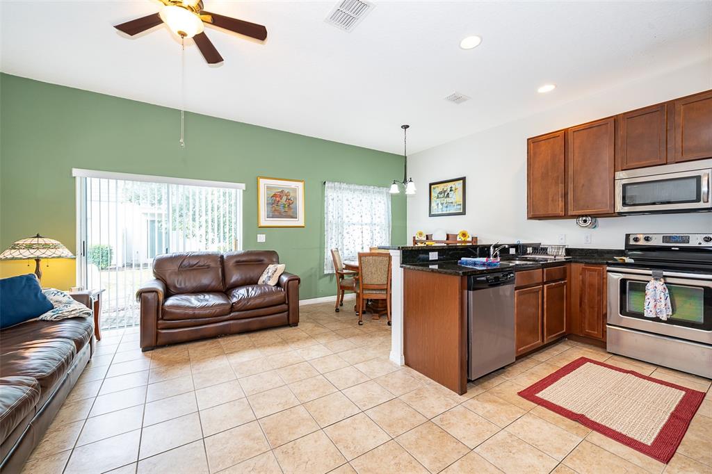 4113 Hedge Maple Place Winter Springs, FL 32708 - Photo 5 of 31 a living room with granite countertop furniture and a fireplace