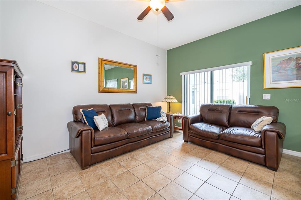 4113 Hedge Maple Place Winter Springs, FL 32708 - Photo 8 of 31 a living room with furniture and a window