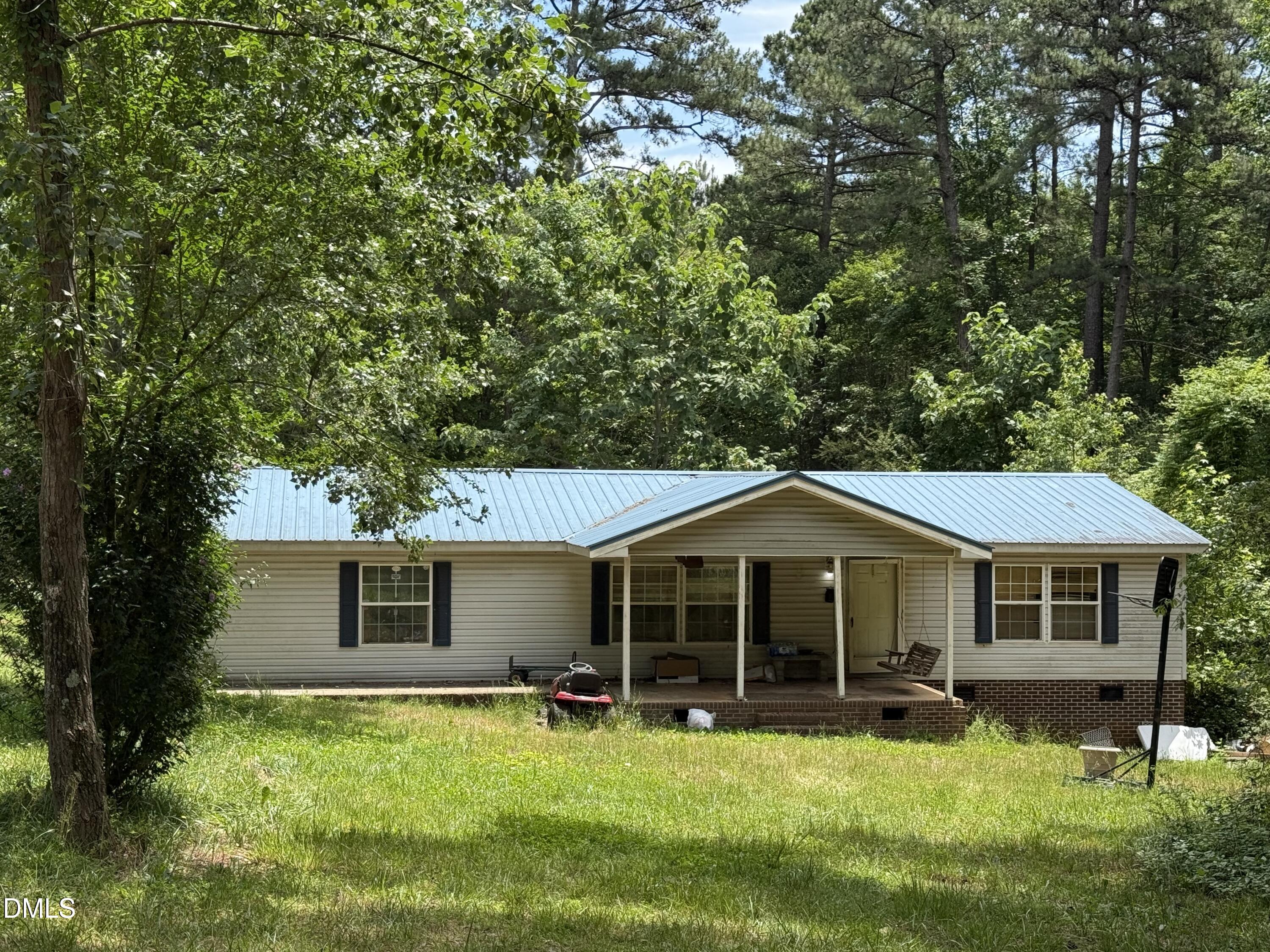 4749 Buckhorn Road Sanford, NC 27330 - Photo 2 of 18 a front view of a house with a yard and trees