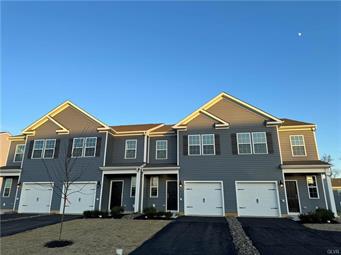 1145 Martin Road Breinigsville, PA 18031 - Photo 23 of 38 A row of modern townhomes features inviting front garages and tidy landscaping.