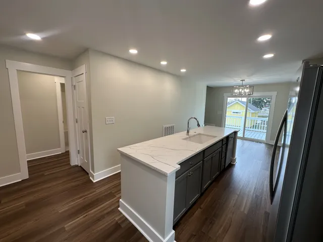 a large white kitchen with a large window