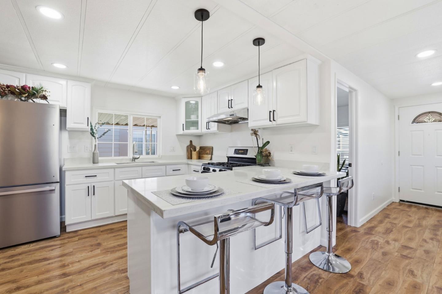 555 Umbarger Road, Unit 31 San Jose, CA 95111 - Photo 5 of 18 a kitchen with stainless steel appliances granite countertop a sink stove and refrigerator