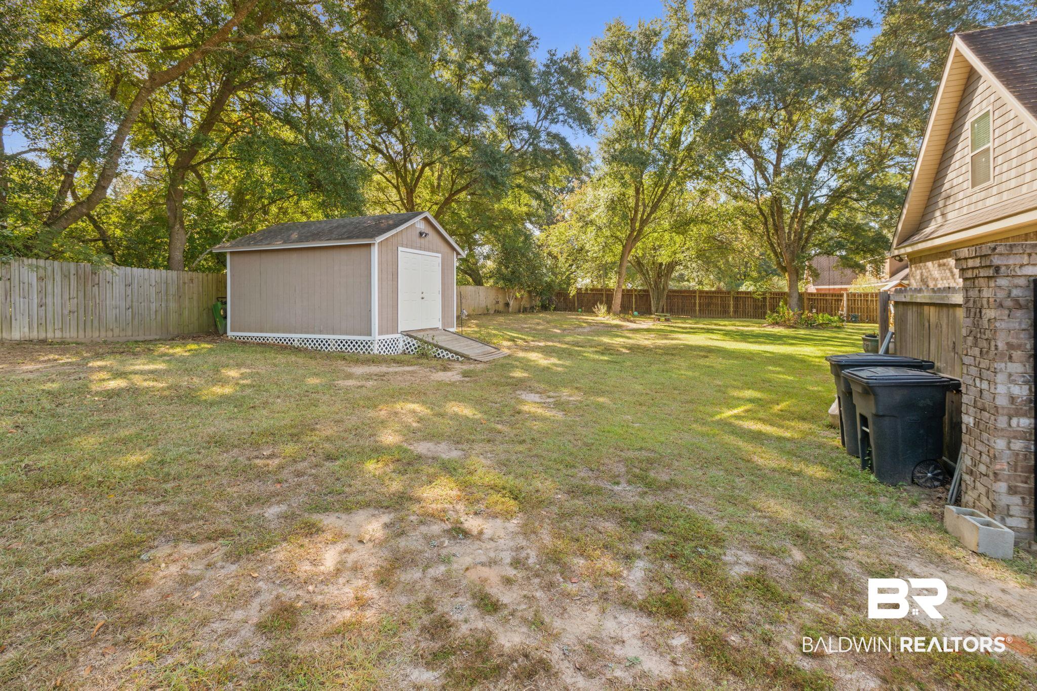 4331 Hamilton Oaks Lane Mobile, AL 36695 - Photo 27 of 38 View of yard with an outbuilding and a storage shed