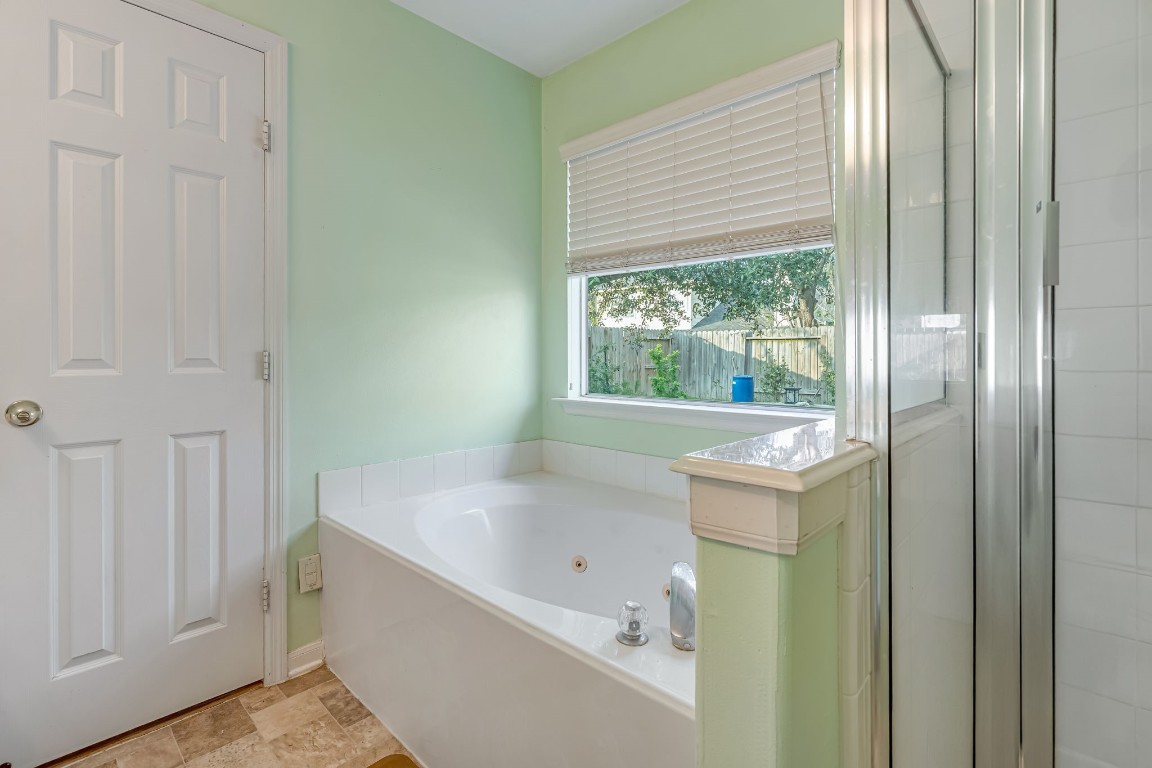 4614 Neches Trail Lane Spring, TX 77388 - Photo 13 of 29 a bathroom with a bathtub and window