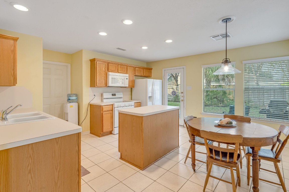 4614 Neches Trail Lane Spring, TX 77388 - Photo 15 of 29 a kitchen with a stove a refrigerator and a table