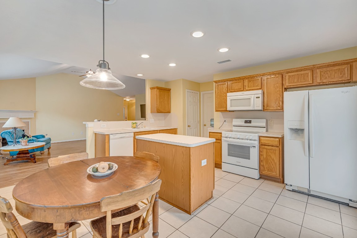 4614 Neches Trail Lane Spring, TX 77388 - Photo 19 of 29 a kitchen with kitchen island a stove a table and chairs