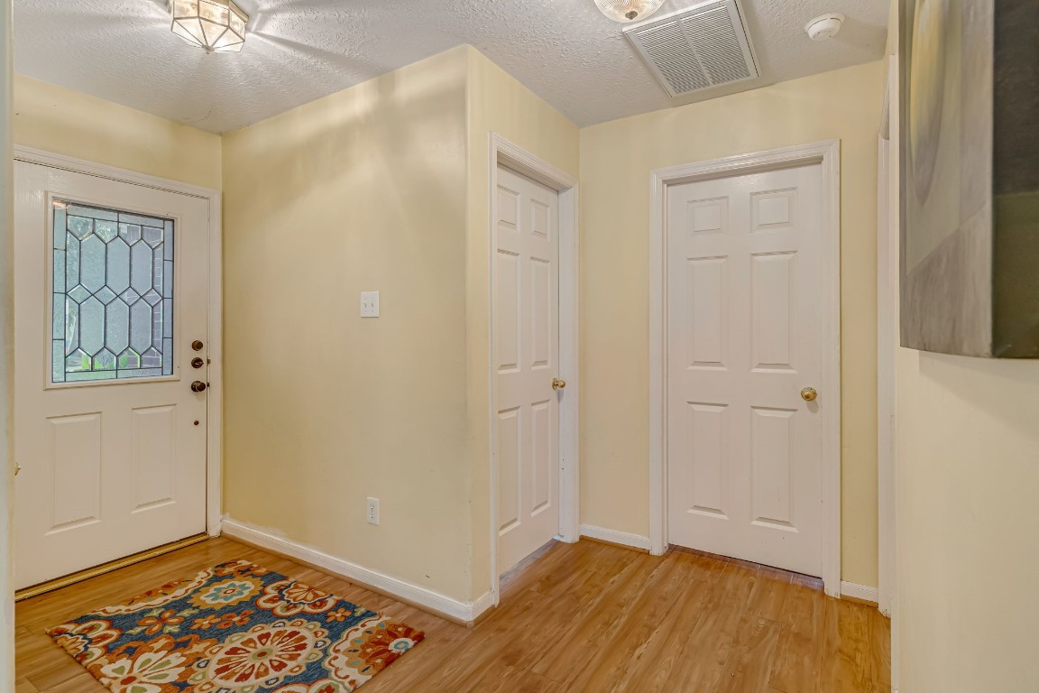 4614 Neches Trail Lane Spring, TX 77388 - Photo 5 of 29 a view of an empty room with window and wooden floor
