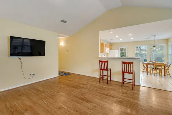 a view of a livingroom with furniture wooden floor and window