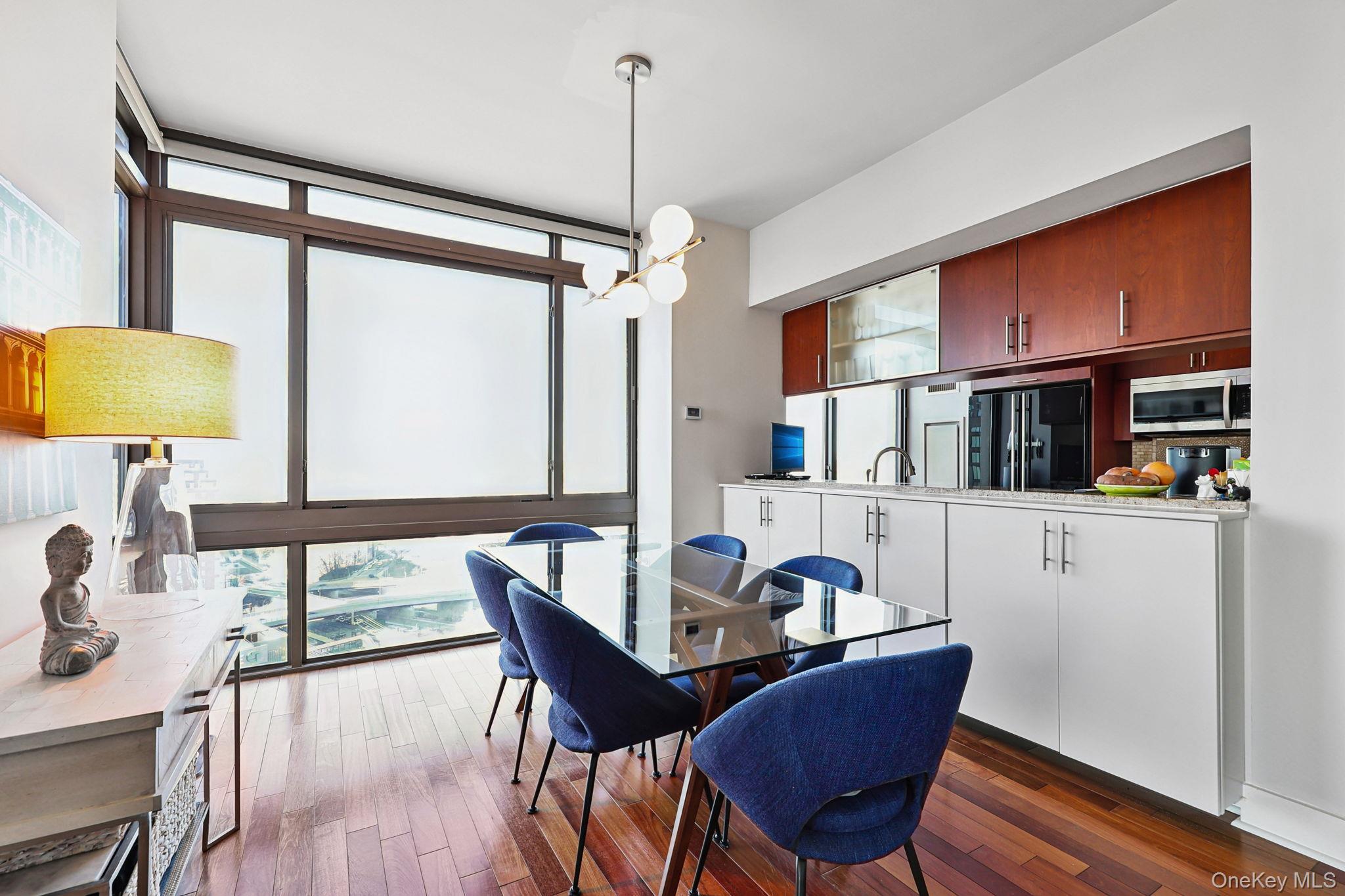 175 Huguenot Street, Unit 2503 New Rochelle, NY 10801 - Photo 11 of 32 a dining room with furniture and window