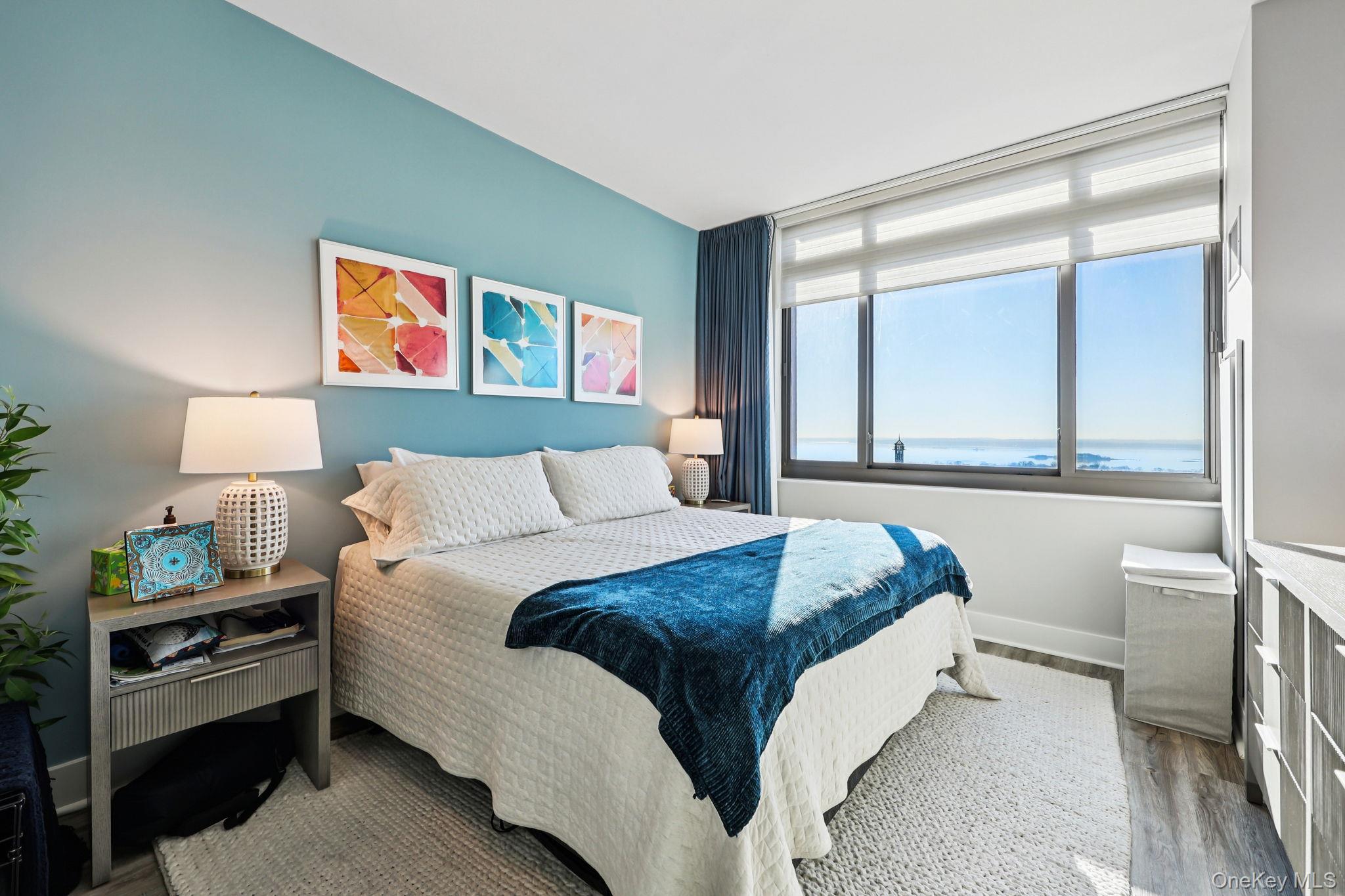 175 Huguenot Street, Unit 2503 New Rochelle, NY 10801 - Photo 16 of 32 a bedroom with a bed and a window