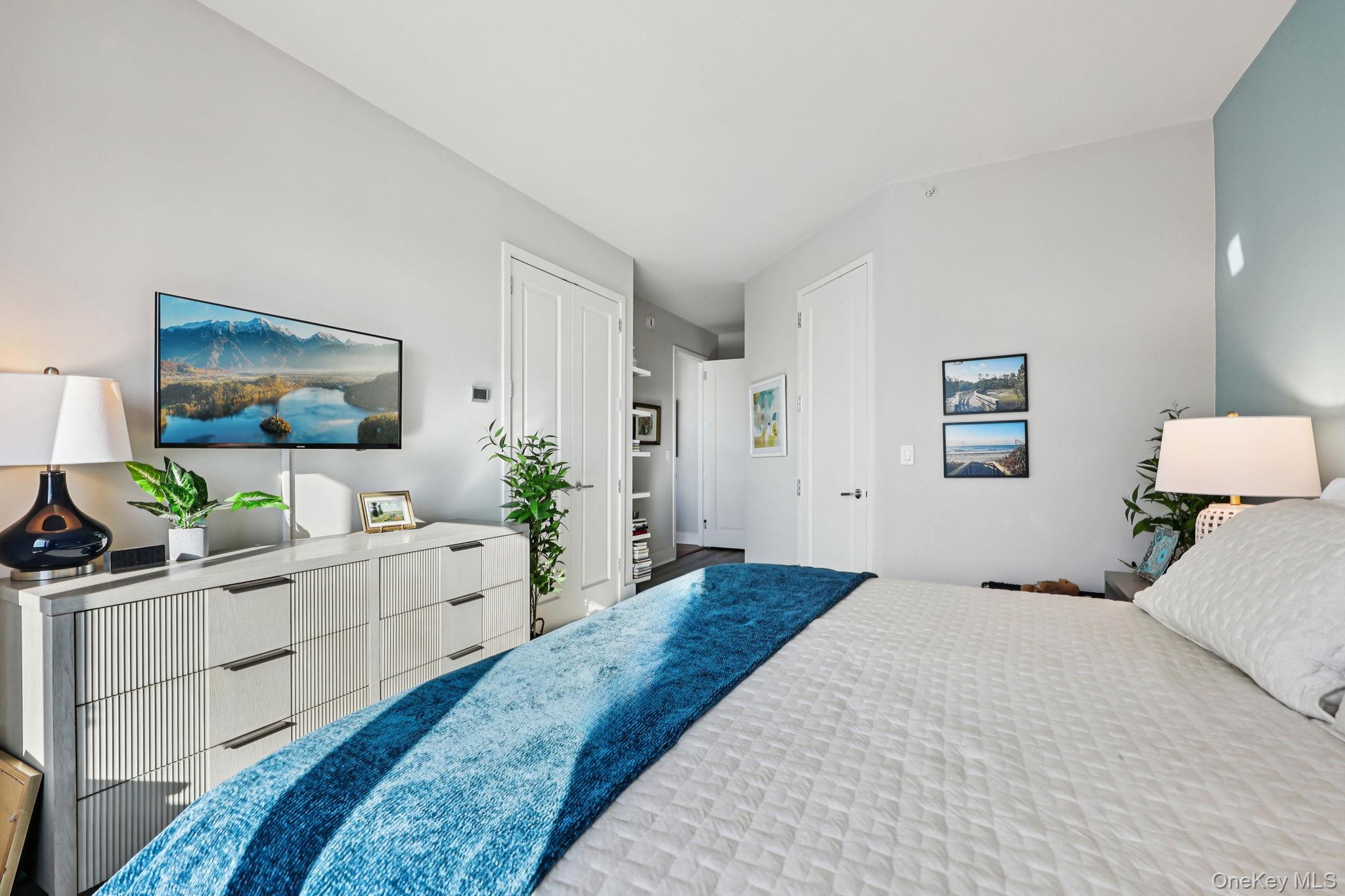 175 Huguenot Street, Unit 2503 New Rochelle, NY 10801 - Photo 18 of 32 a bedroom with a bed and a flat screen tv
