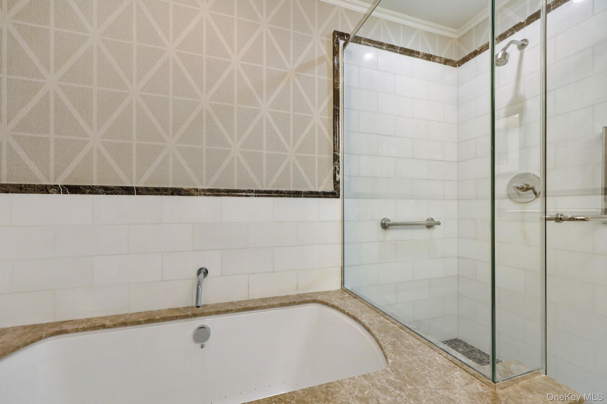175 Huguenot Street, Unit 2503 New Rochelle, NY 10801 - Photo 20 of 32 a bathroom with a bathtub and a shower