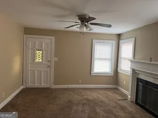 a view of empty room with windows and fireplace