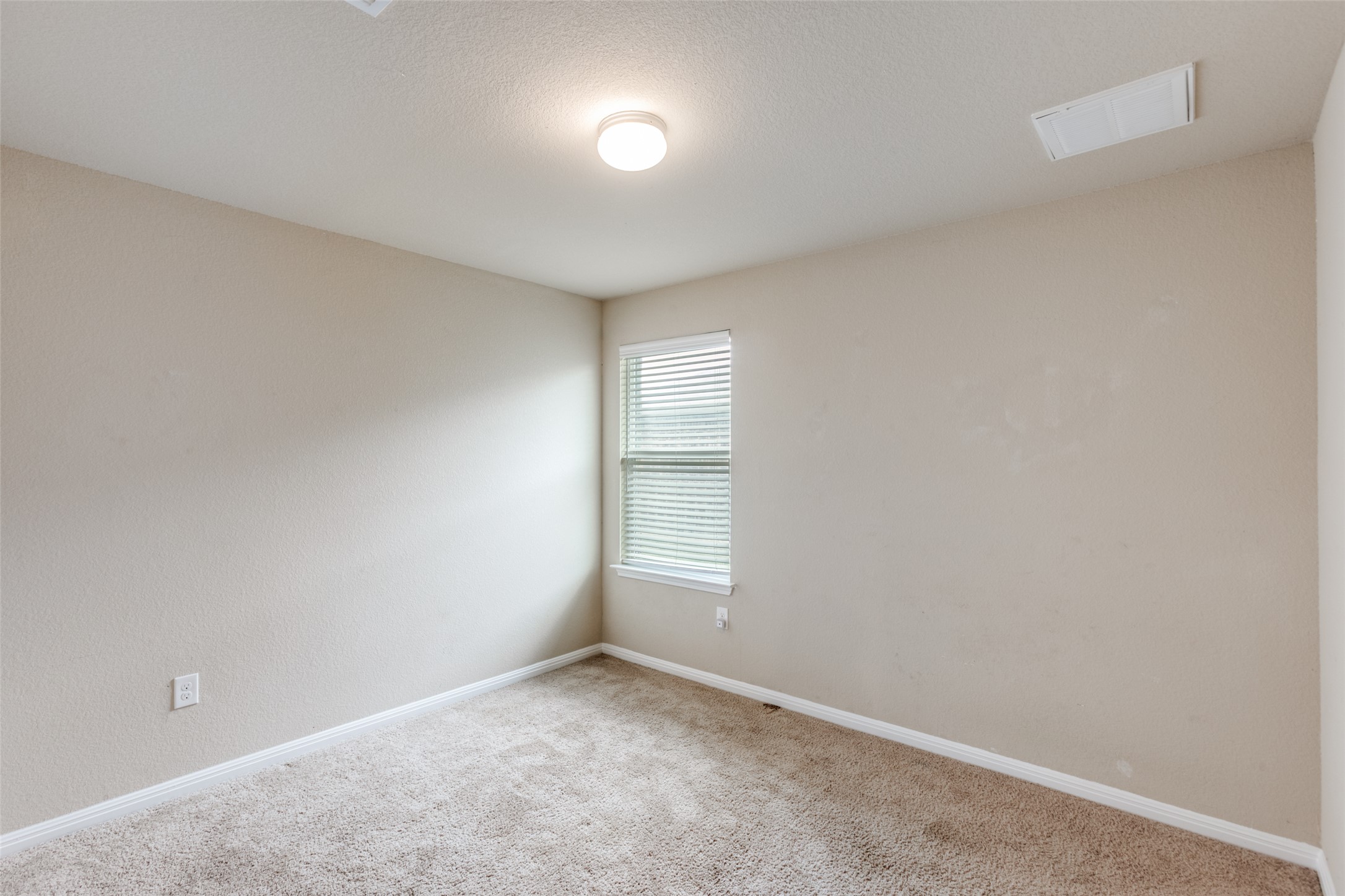 2909 Centrum Drive Austin, TX 78754 - Photo 25 of 30 This room features light-colored walls, carpeted flooring, and a window with blinds