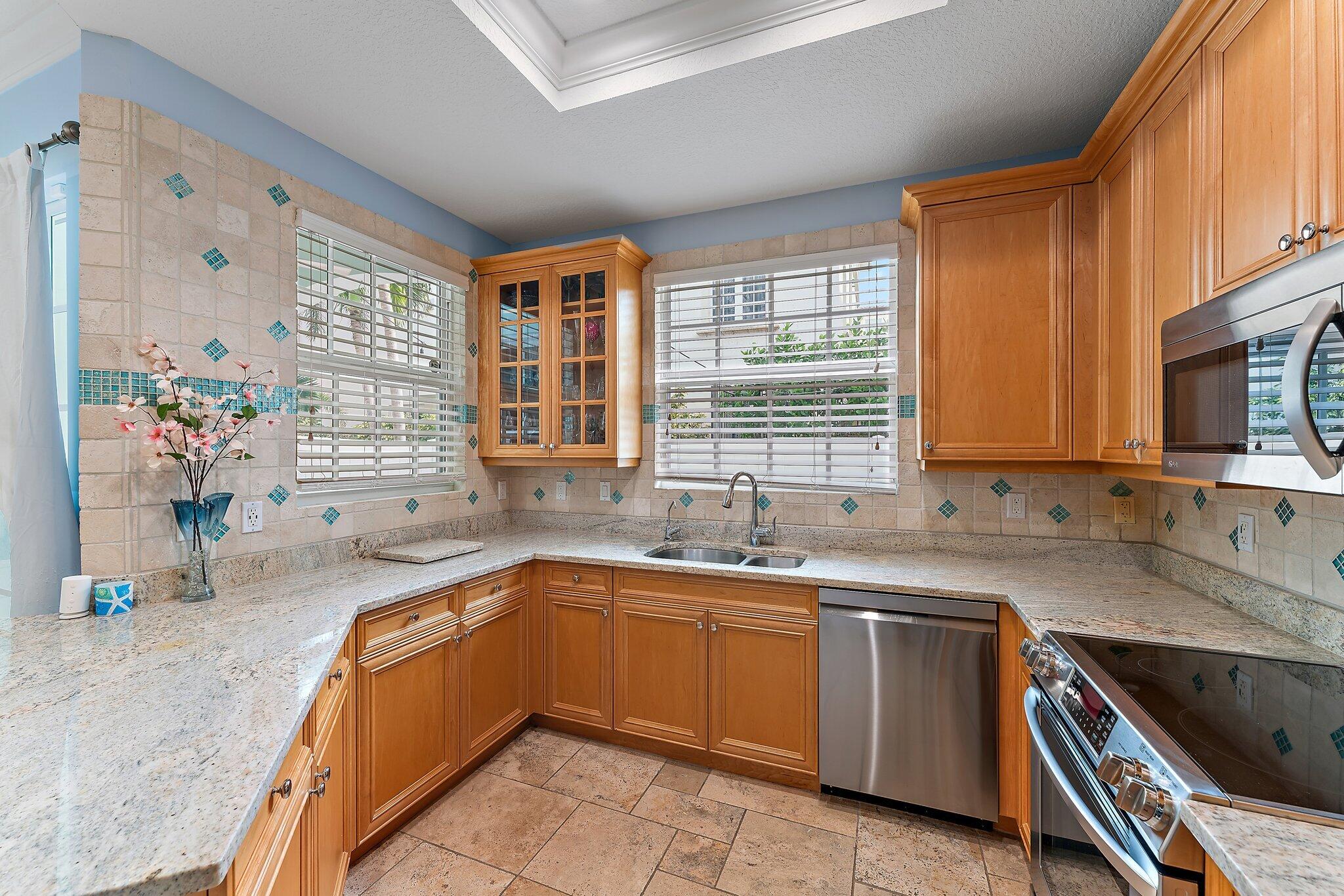 455 Ocean Ridge Way Juno Beach, FL 33408 - Photo 16 of 39 a kitchen with a sink stove and microwave