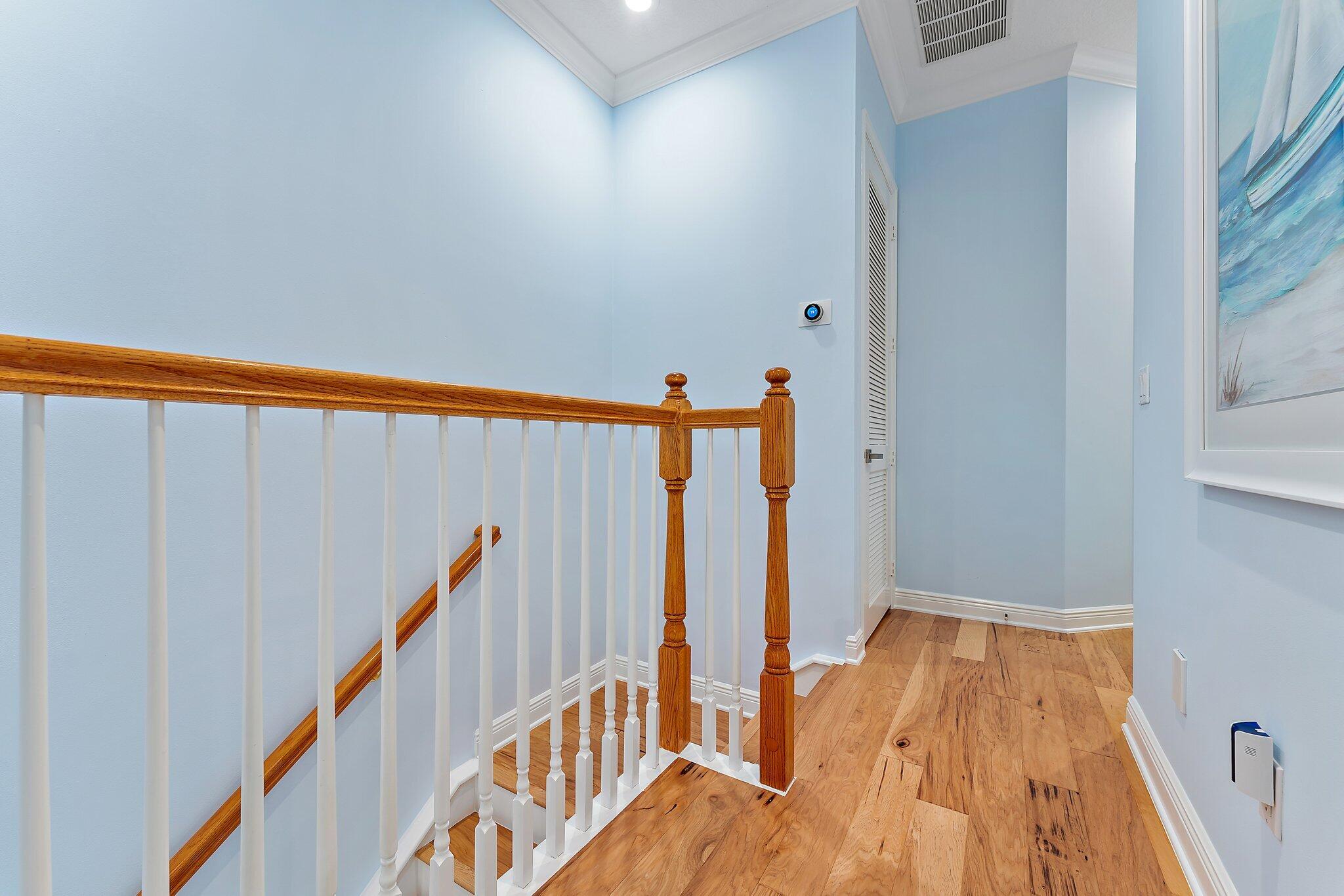 455 Ocean Ridge Way Juno Beach, FL 33408 - Photo 23 of 39 a view of a hallway with wooden floor and stairs