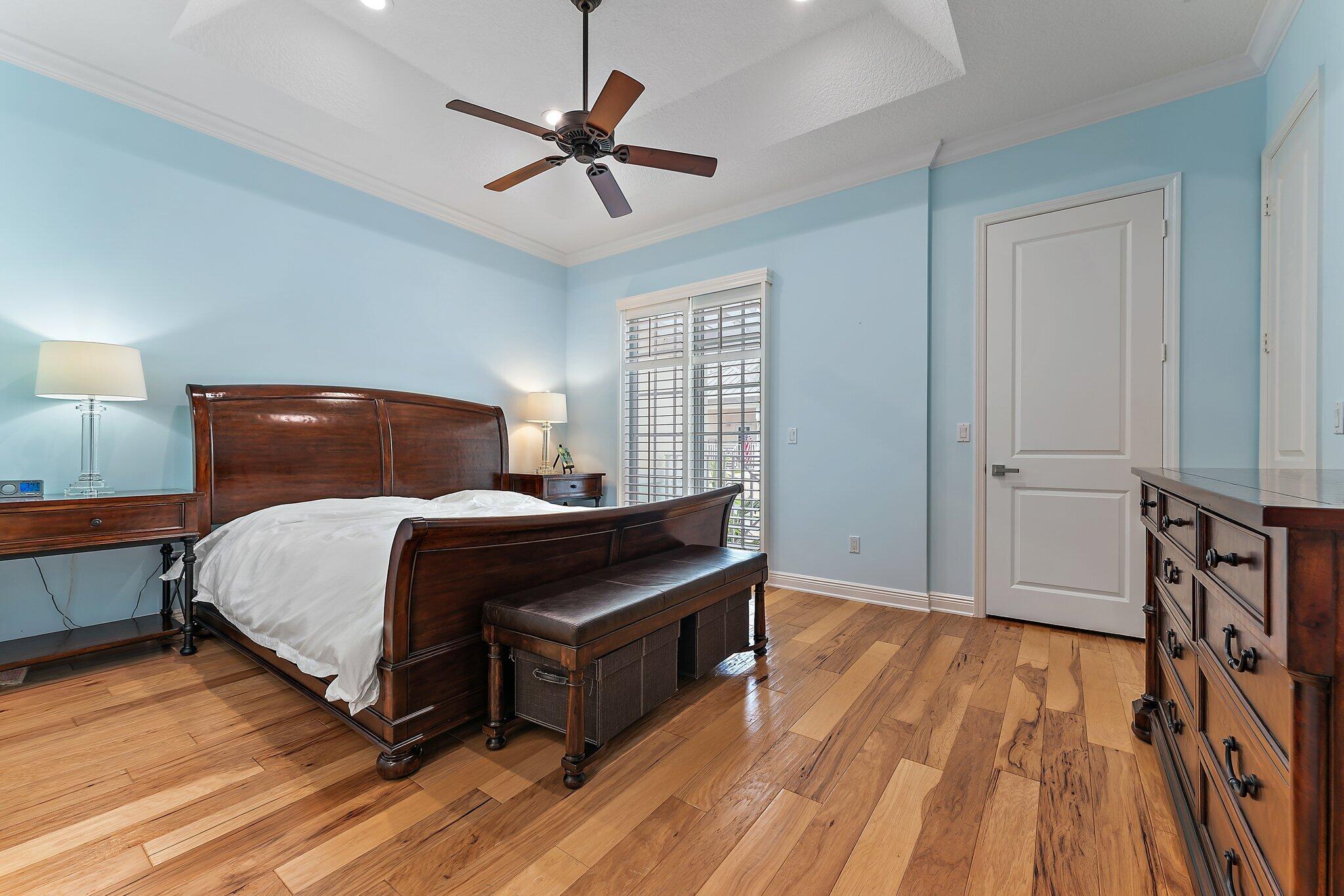 455 Ocean Ridge Way Juno Beach, FL 33408 - Photo 24 of 39 a bedroom with a bed and wooden floor