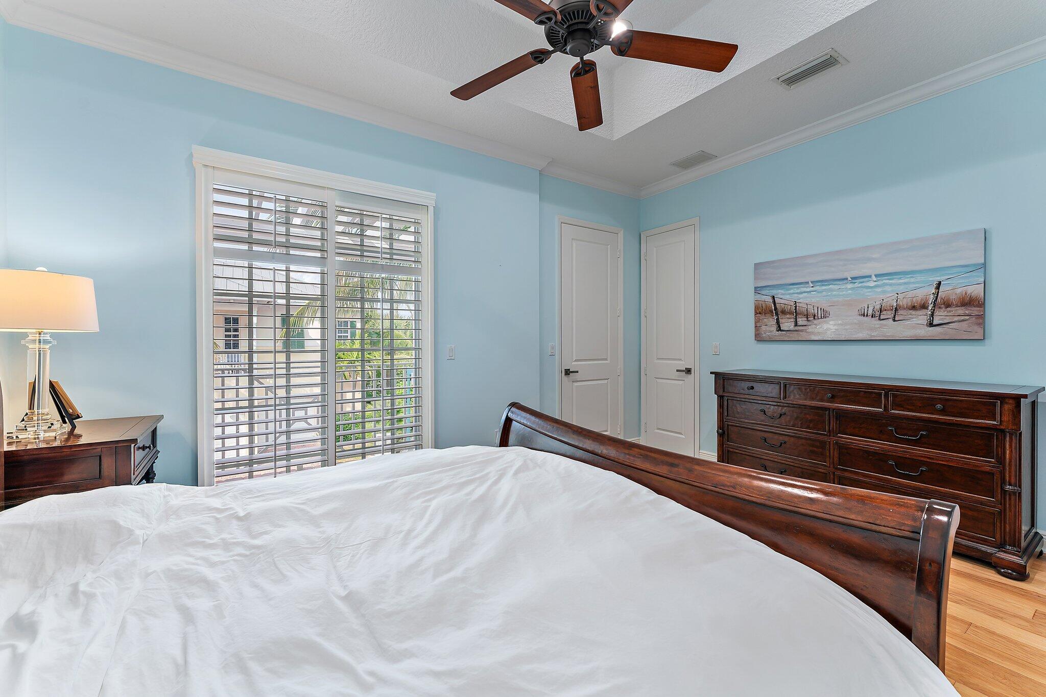 455 Ocean Ridge Way Juno Beach, FL 33408 - Photo 25 of 39 a bedroom with a large bed and a chandelier