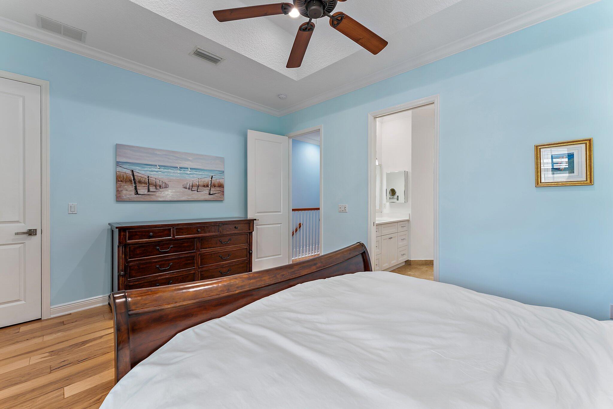 455 Ocean Ridge Way Juno Beach, FL 33408 - Photo 26 of 39 a bedroom with a bed and a chandelier