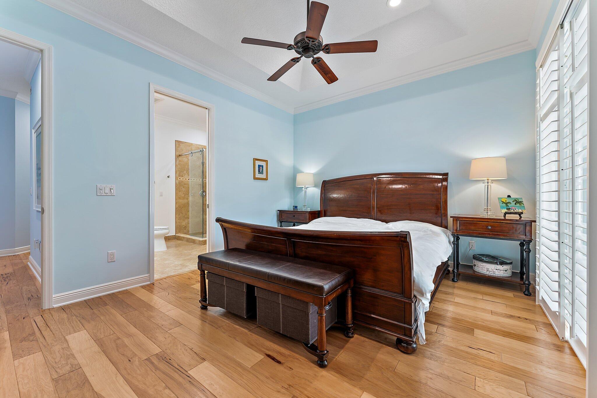 455 Ocean Ridge Way Juno Beach, FL 33408 - Photo 27 of 39 a bedroom with a bed and wooden floor