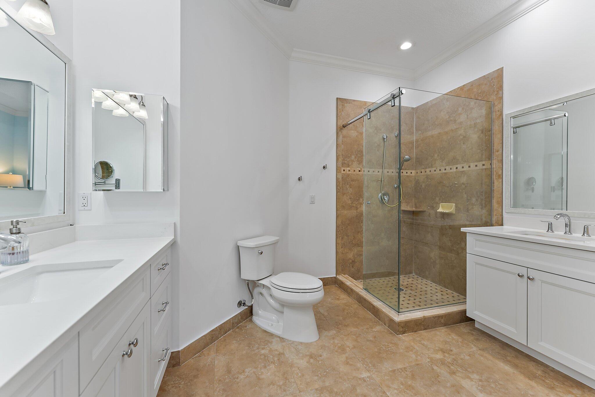455 Ocean Ridge Way Juno Beach, FL 33408 - Photo 29 of 39 a bathroom with a double vanity sink toilet and shower