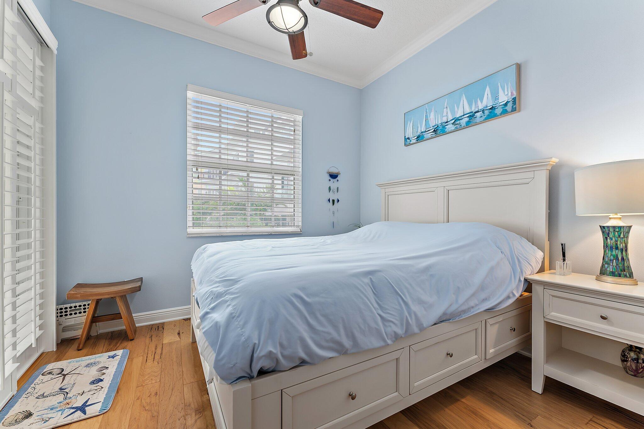 455 Ocean Ridge Way Juno Beach, FL 33408 - Photo 34 of 39 a bedroom with a bed and a lamp on dresser