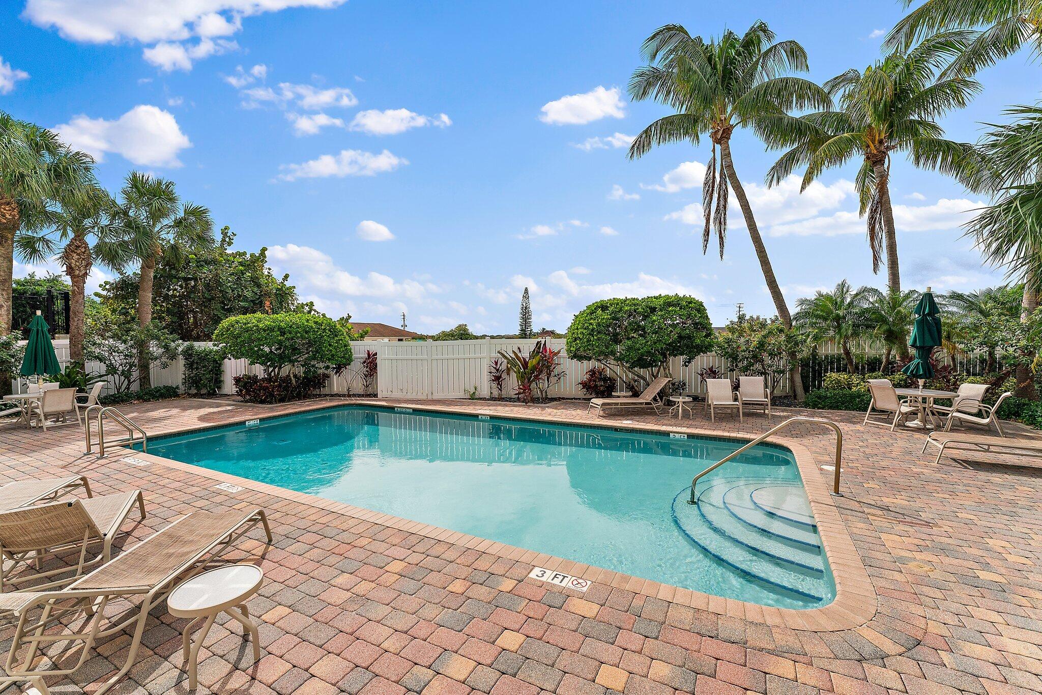 455 Ocean Ridge Way Juno Beach, FL 33408 - Photo 36 of 39 a view of a swimming pool and lounge chair